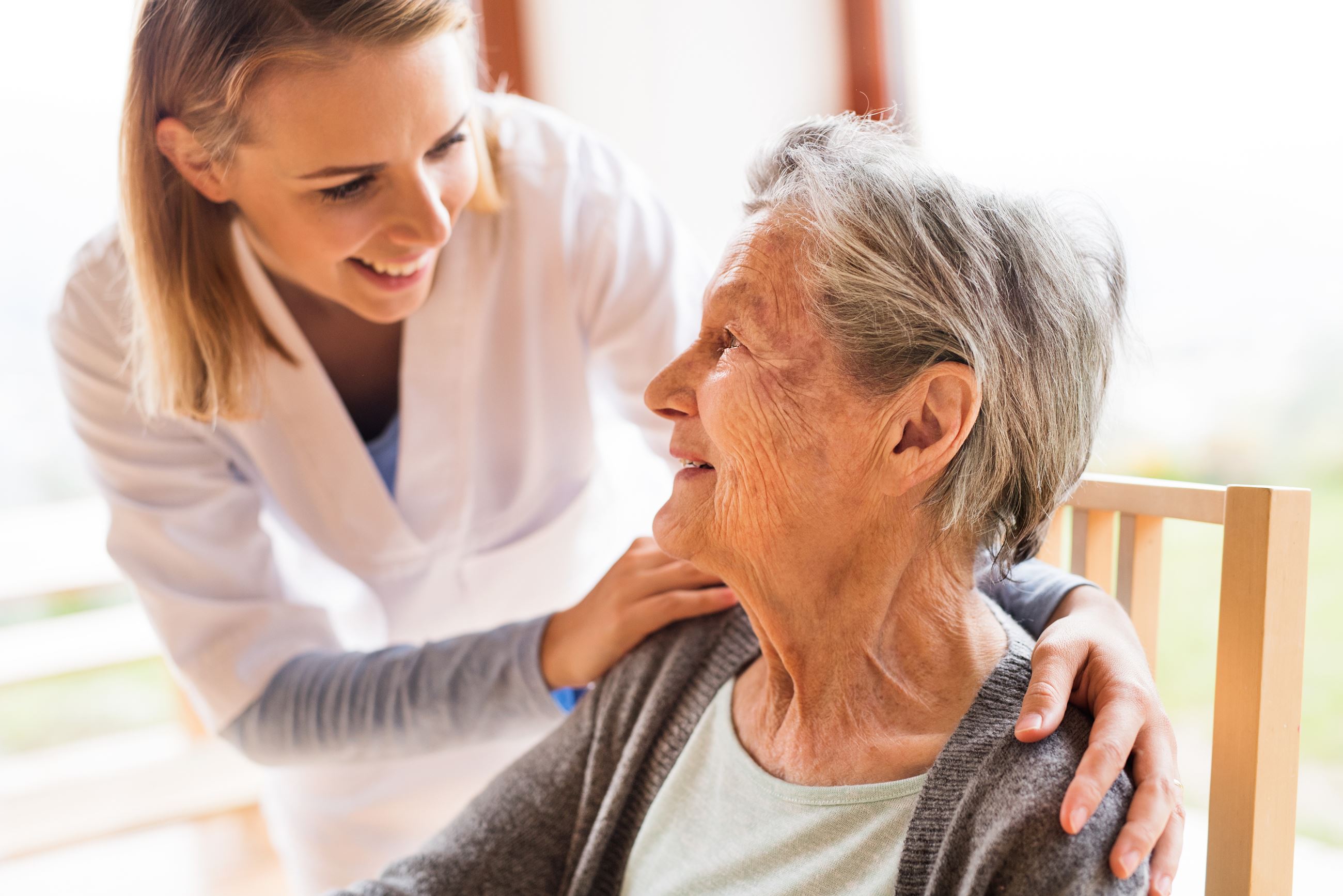 Image of an older person with their caregiver