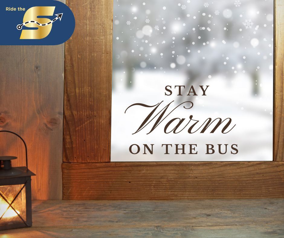 Stay warm on the bus, Ride The S logo, image looking out of a window with snow falling outside