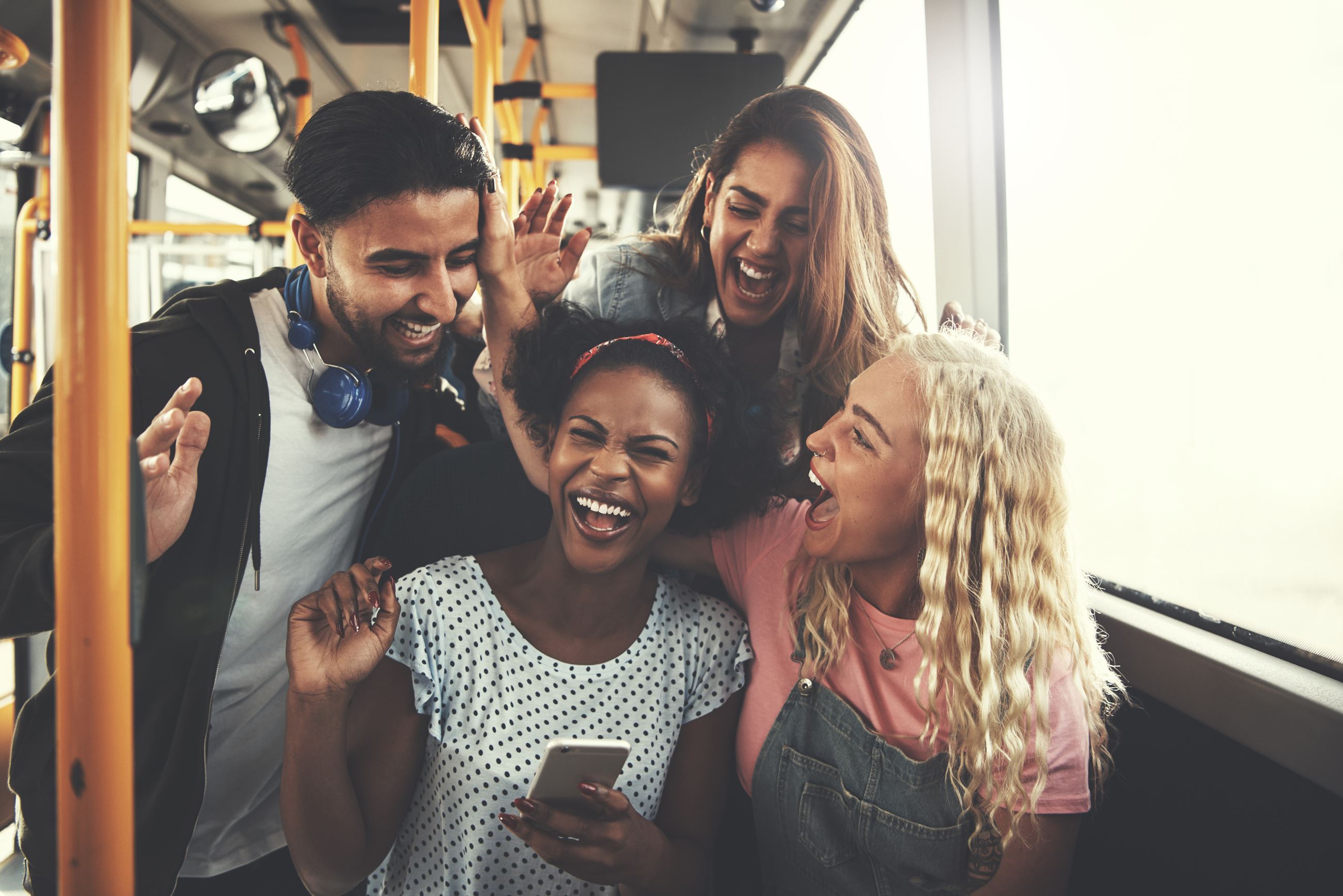 Image of a group of teenagers laughing and having fun on a bus