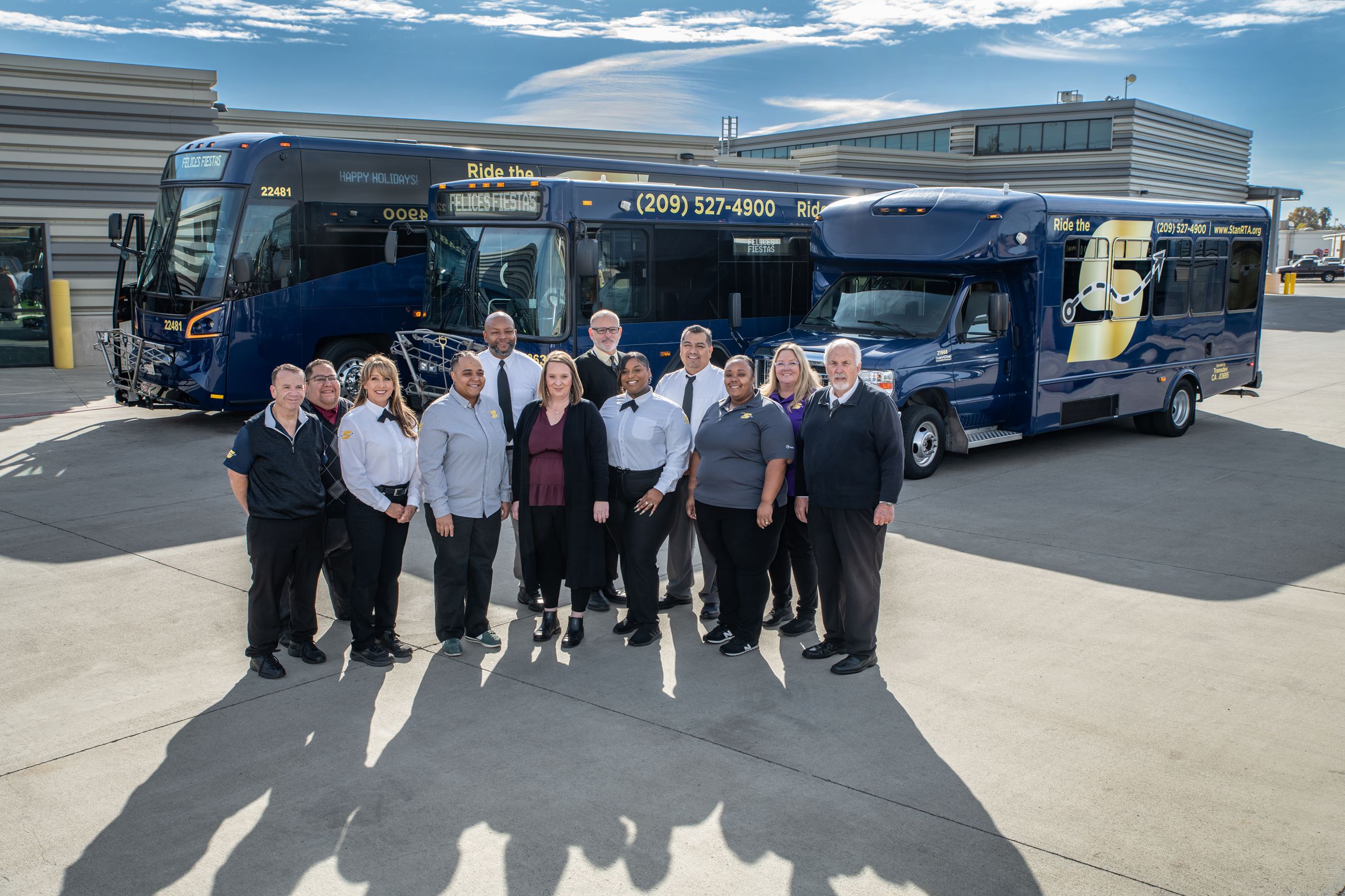 Image of award winning team in front of The S buses